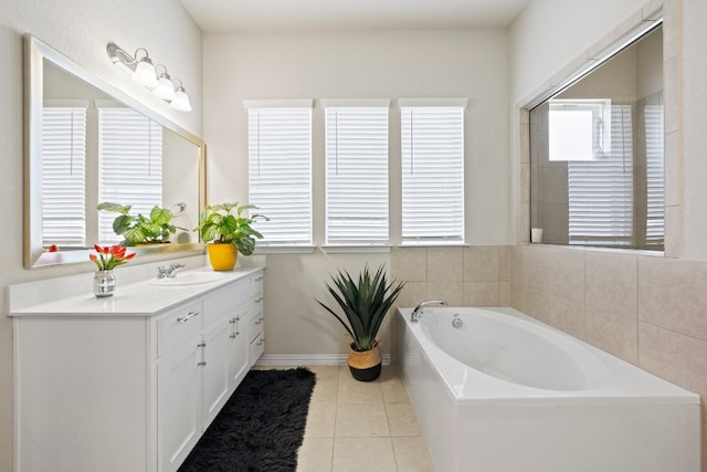 bathroom featuring tile patterned floors, vanity, and a bath