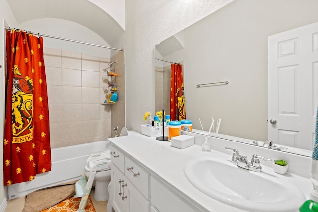 full bathroom with tile patterned flooring, vanity, toilet, and shower / bath combo with shower curtain