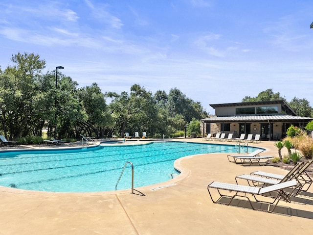 view of swimming pool with a patio area