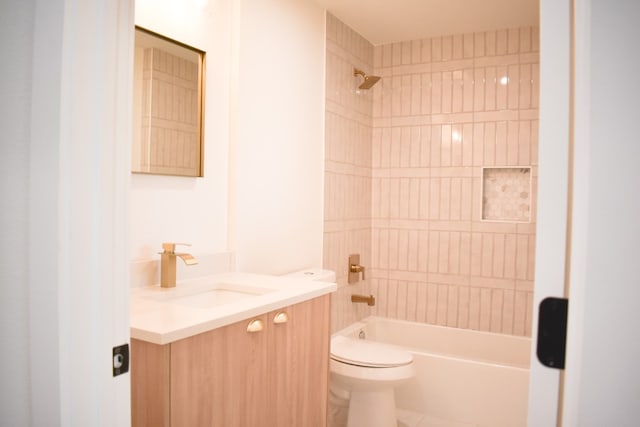 full bathroom with tiled shower / bath, vanity, and toilet