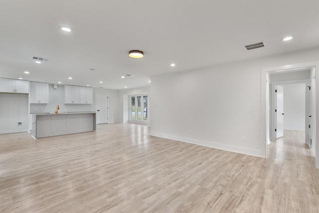 unfurnished living room featuring light hardwood / wood-style flooring