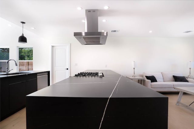 kitchen with lofted ceiling, sink, a kitchen island, stainless steel appliances, and extractor fan