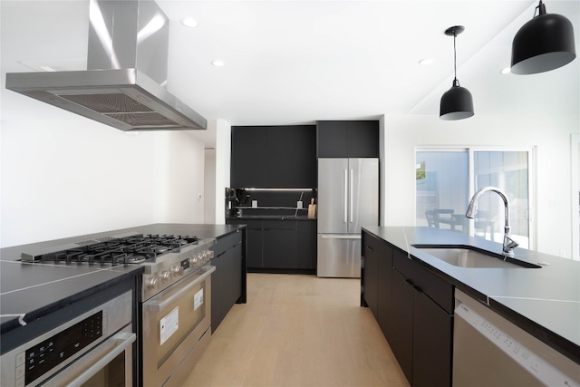 kitchen with ventilation hood, sink, light hardwood / wood-style flooring, appliances with stainless steel finishes, and decorative light fixtures