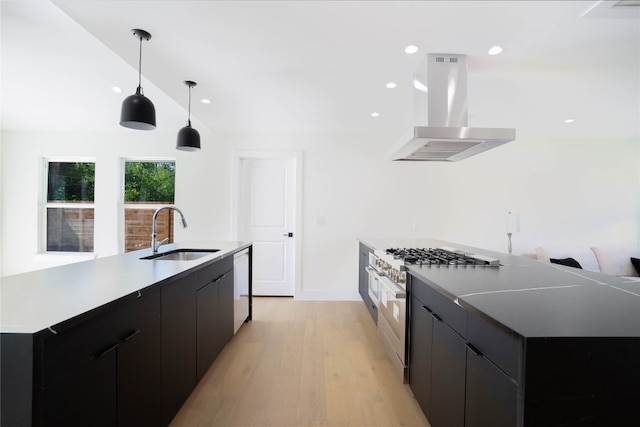 kitchen with pendant lighting, sink, a large island, and range hood