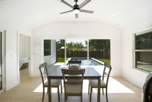 dining room featuring ceiling fan, light hardwood / wood-style floors, and lofted ceiling