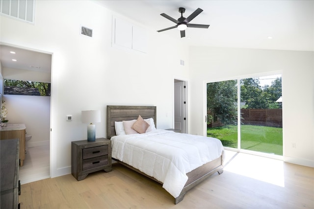 bedroom featuring access to exterior, light wood-type flooring, high vaulted ceiling, and ceiling fan