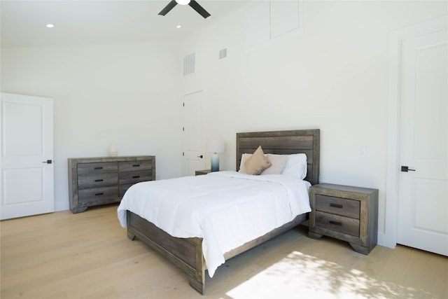 bedroom featuring high vaulted ceiling, light hardwood / wood-style flooring, and ceiling fan