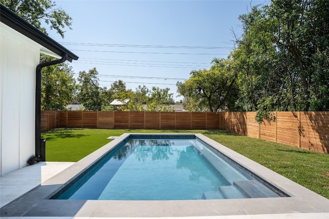 view of pool featuring a yard