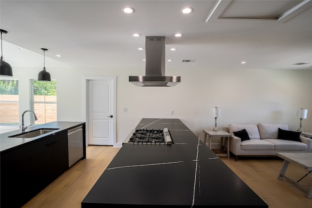 kitchen with sink, light hardwood / wood-style flooring, island exhaust hood, decorative light fixtures, and appliances with stainless steel finishes