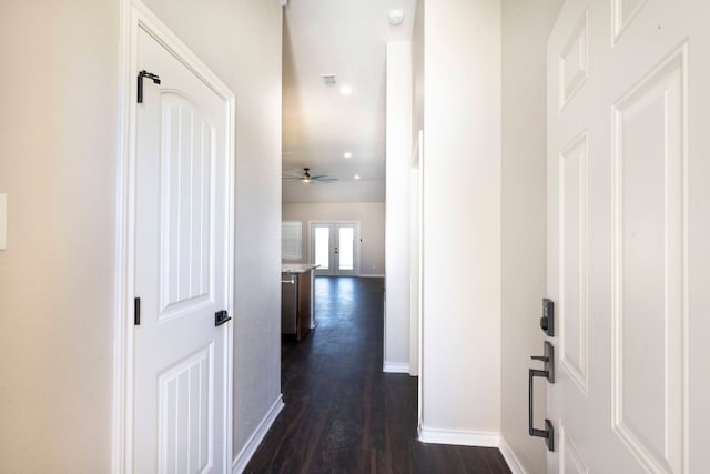 corridor with dark wood-type flooring and french doors