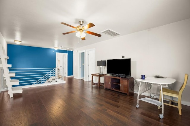 living room featuring dark hardwood / wood-style flooring and ceiling fan