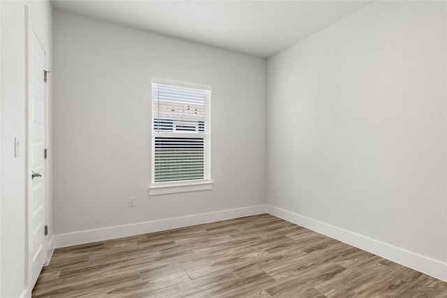 spare room with light hardwood / wood-style flooring