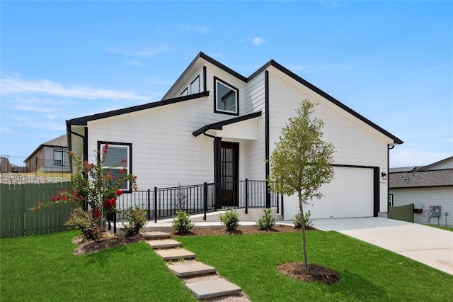 view of front of property featuring a front lawn and a garage