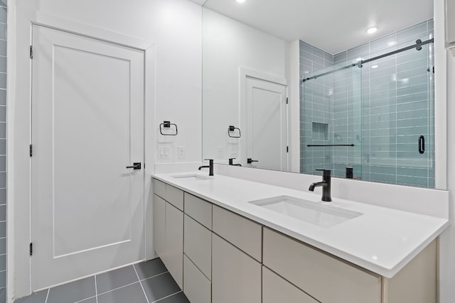 bathroom with tile patterned flooring, a shower with door, and vanity