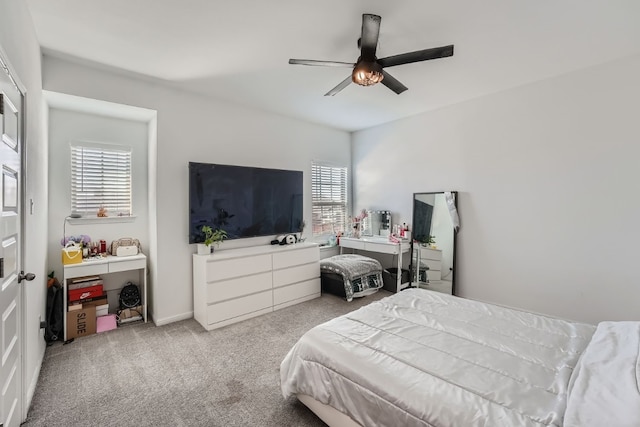 carpeted bedroom with multiple windows and ceiling fan