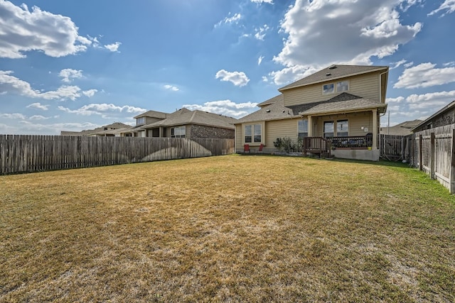 back of house featuring a lawn