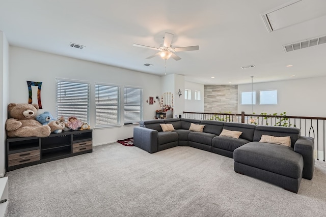 carpeted living room featuring ceiling fan