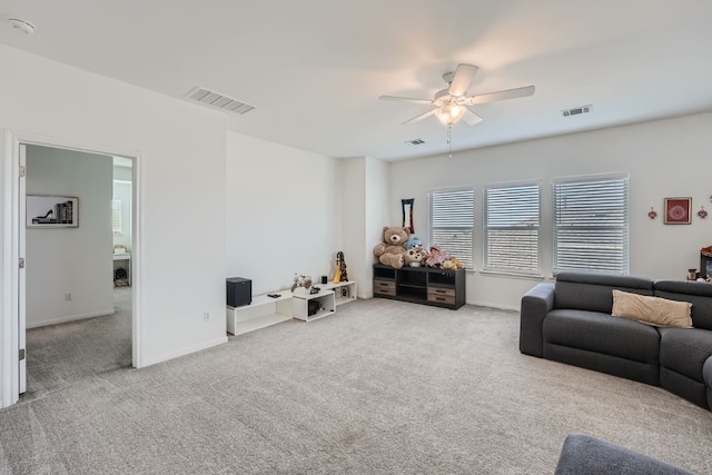 carpeted living room featuring ceiling fan