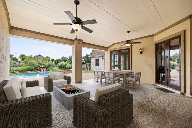 view of patio / terrace featuring outdoor dining space, french doors, an outdoor pool, and an outdoor living space with a fire pit