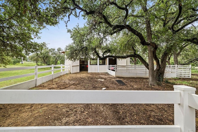 view of yard featuring an outbuilding and an exterior structure