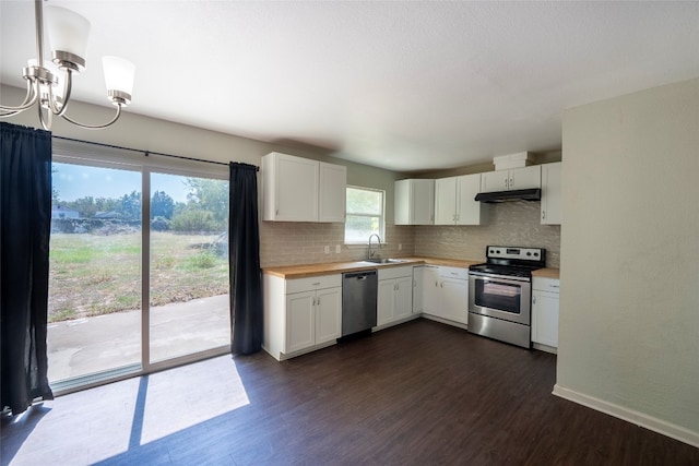 kitchen with dark wood-type flooring, appliances with stainless steel finishes, sink, and white cabinets