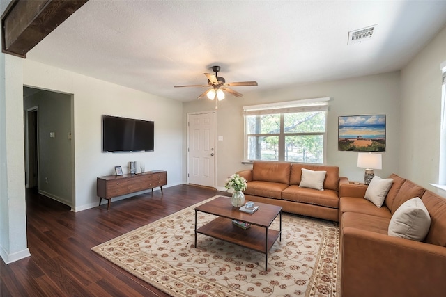 living room featuring dark hardwood / wood-style flooring and ceiling fan