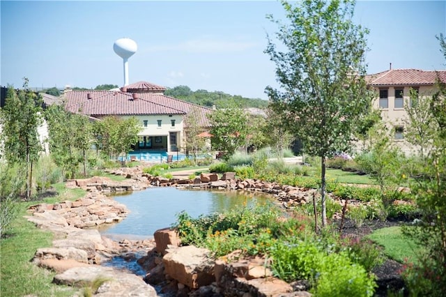 view of property's community featuring a swimming pool and a patio