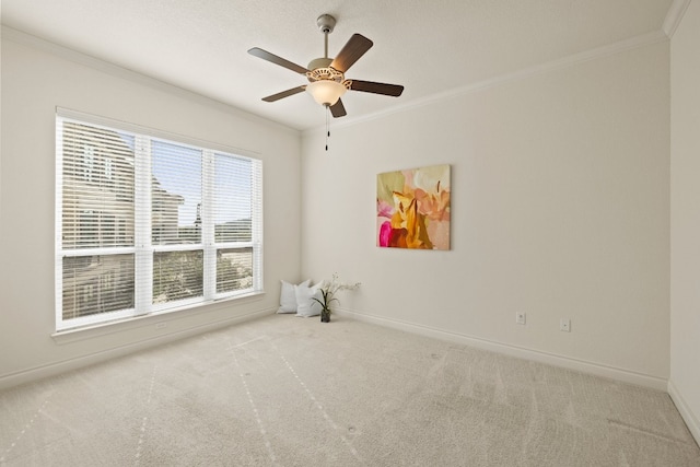 carpeted empty room with crown molding and ceiling fan