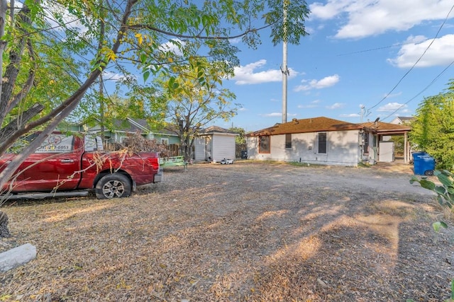 ranch-style home with a storage unit