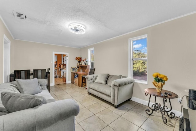 living room featuring crown molding, light tile patterned floors, and a textured ceiling