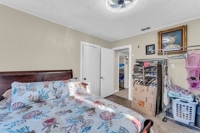 carpeted bedroom featuring ornamental molding and a textured ceiling