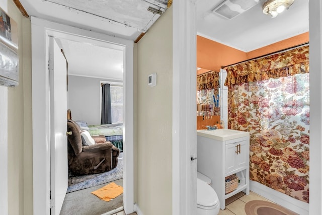 bathroom with walk in shower, tile patterned flooring, vanity, and toilet