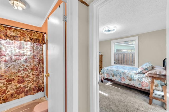 carpeted bedroom featuring a textured ceiling