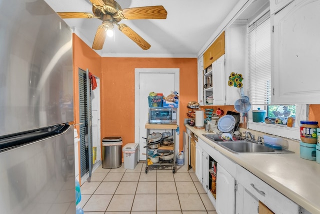 kitchen with white cabinetry, sink, ceiling fan, stainless steel appliances, and light tile patterned flooring