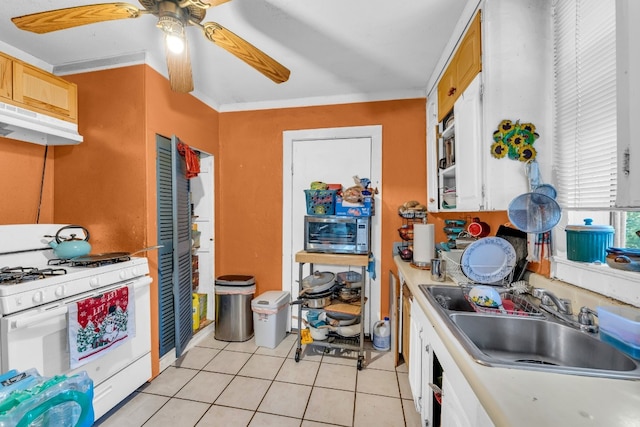 kitchen with ornamental molding, ceiling fan, white range with gas cooktop, sink, and light tile patterned floors