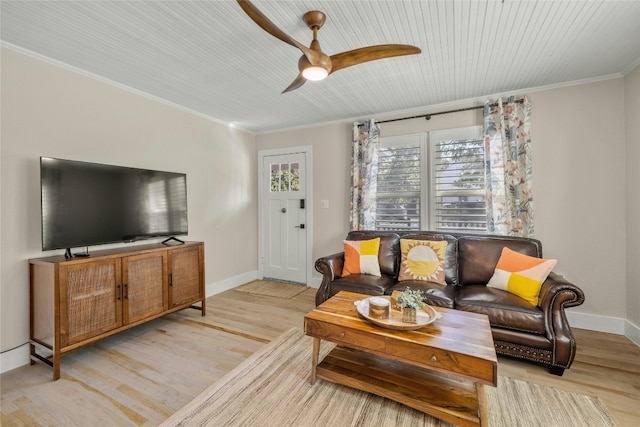 living room with ceiling fan, ornamental molding, and light hardwood / wood-style floors