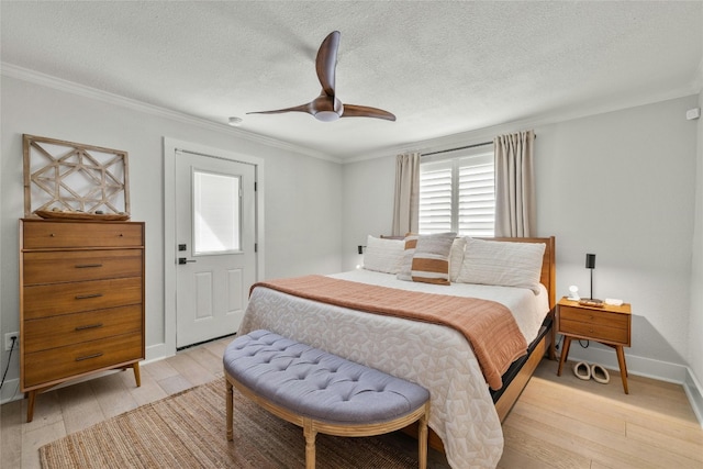 bedroom featuring a textured ceiling, crown molding, light wood-type flooring, and ceiling fan