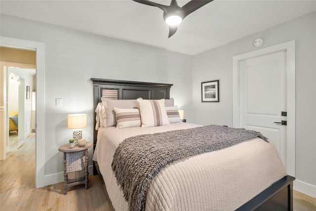 bedroom with hardwood / wood-style flooring and ceiling fan