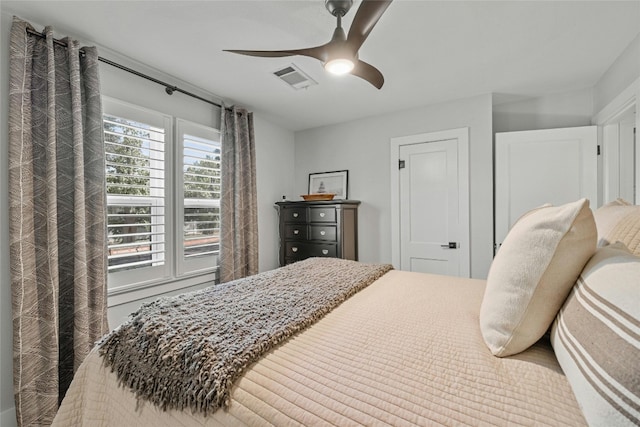 bedroom with multiple windows and ceiling fan