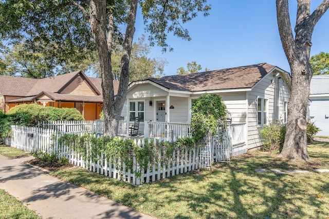 view of front of property with a front yard and a porch