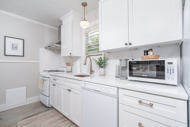 kitchen with crown molding, white appliances, light hardwood / wood-style floors, and white cabinets