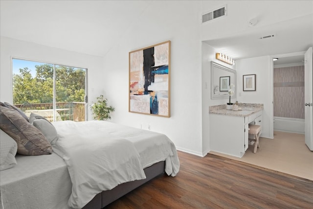 bedroom featuring dark hardwood / wood-style floors and vaulted ceiling