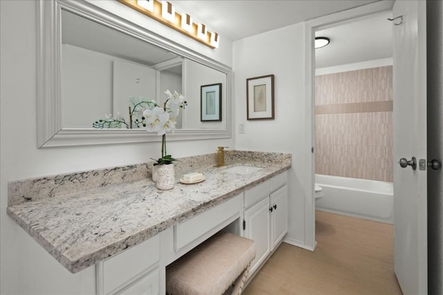 full bathroom with toilet, vanity, and washtub / shower combination