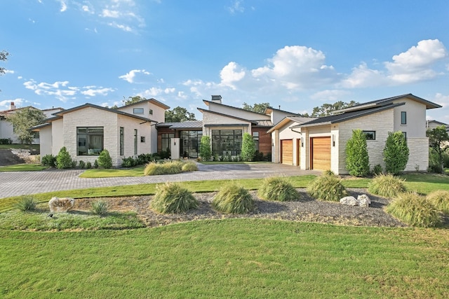 view of front of property with a front yard and a garage