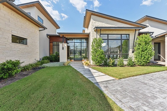 501 Delayne Dr, Austin, TX 78737 - doorway to property with stone siding, a lawn, and stucco siding