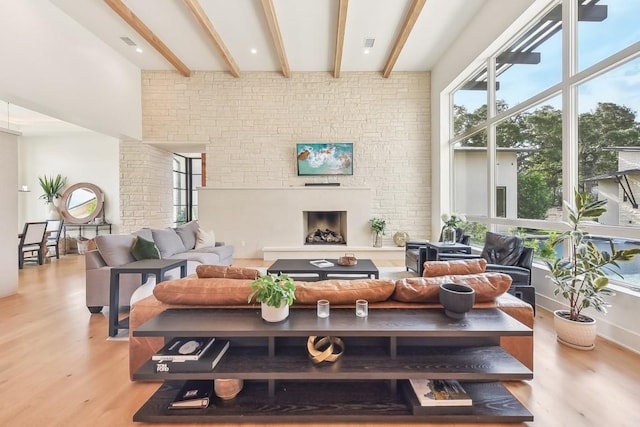 501 Delayne Dr, Austin, TX 78737 - living room with light wood-style floors, beamed ceiling, and a large fireplace