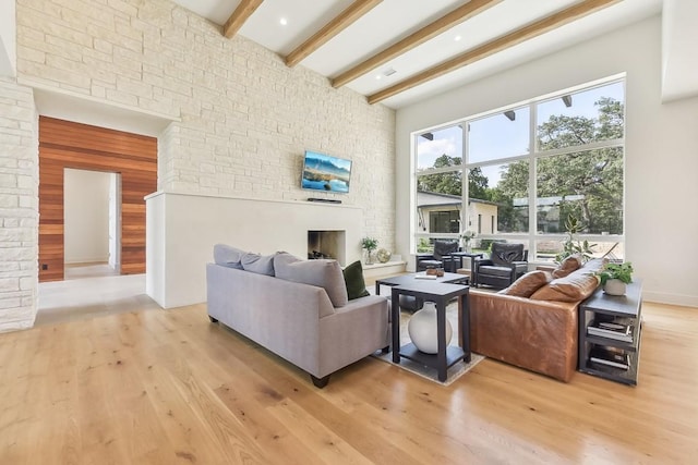 501 Delayne Dr, Austin, TX 78737 - living room with a fireplace, beamed ceiling, light wood-type flooring, and a high ceiling