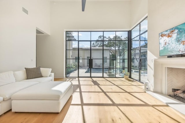 501 Delayne Dr, Austin, TX 78737 - living room with a towering ceiling, wood finished floors, plenty of natural light, a ceiling fan, and a sunroom