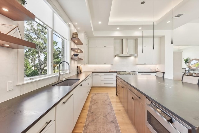 501 Delayne Dr, Austin, TX 78737 - kitchen with open shelves, wall chimney exhaust hood, healthy amount of natural light, dark countertops, and recessed lighting