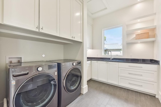 501 Delayne Dr, Austin, TX 78737 - laundry area with washing machine and clothes dryer, cabinet space, light wood finished floors, and attic access
